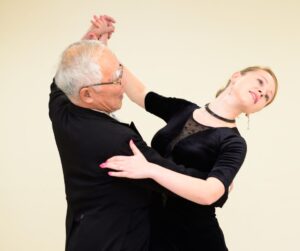 couple ballroom dancing wearing black outfits