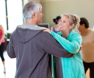 older couple dancing in a ballroom dance class