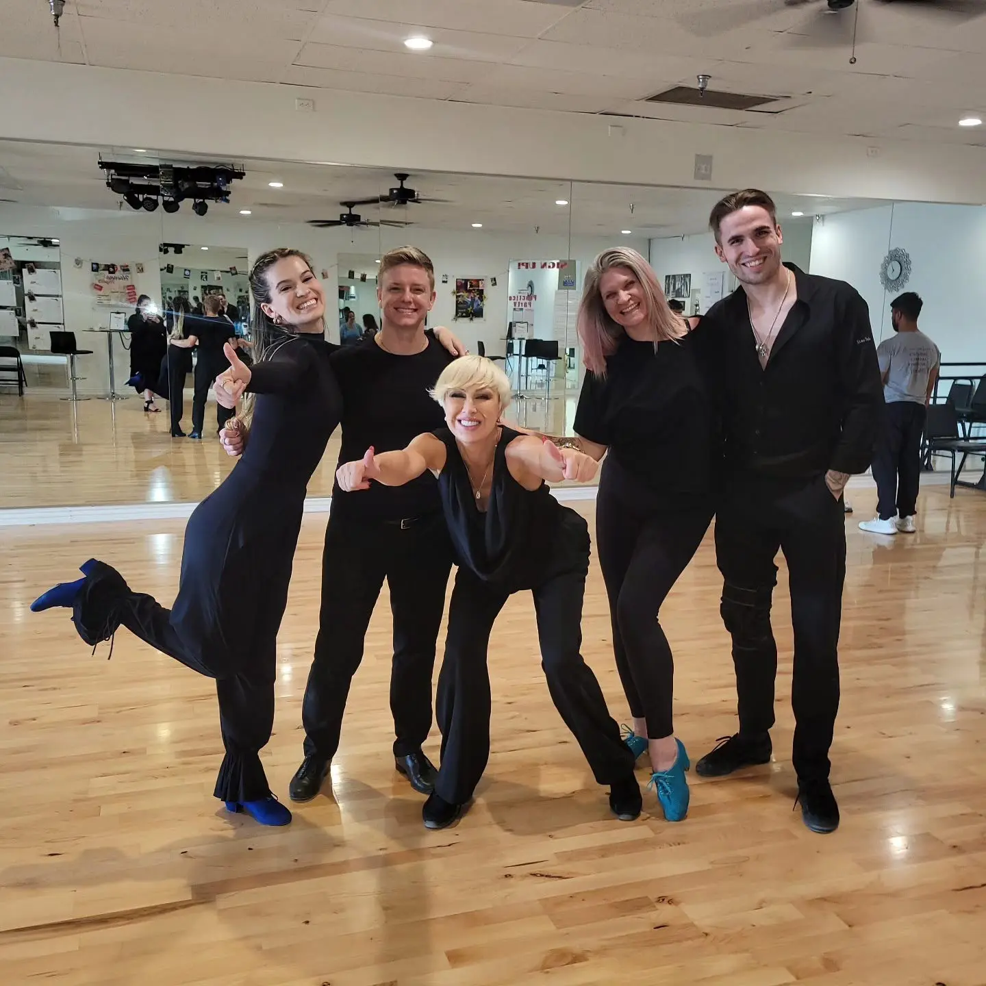 Group dance classes in Scottsdale AZ with students and instructors posing together in a ballroom dance studio.