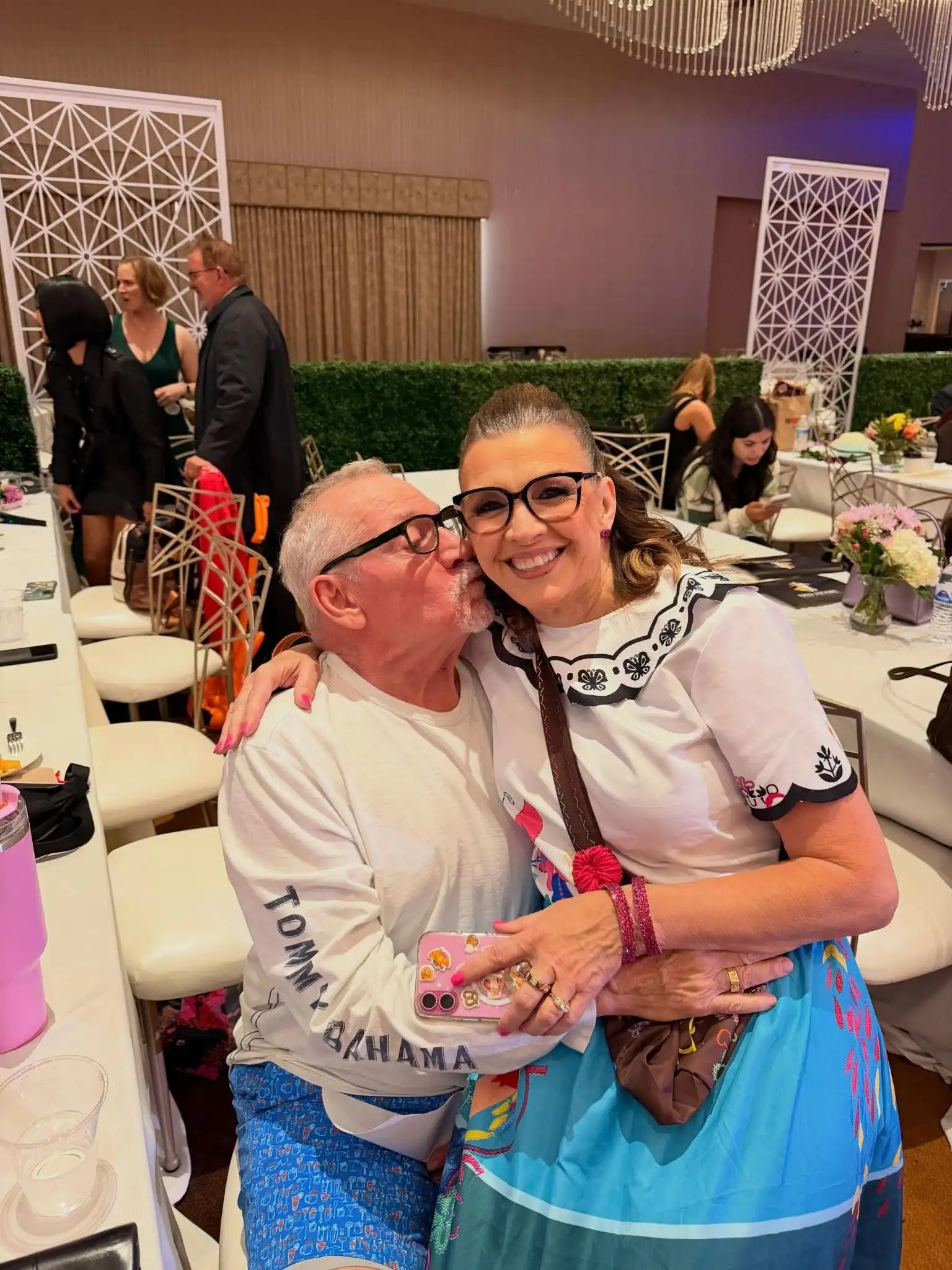 An elderly couple kissing and expressing their joy after learning new dance moves by taking private dance lessons in Scottsdale, AZ.