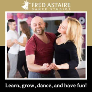A couple dances together in a studio, highlighting why you might Choose Salsa for Social Dancing while learning, growing, and having fun.