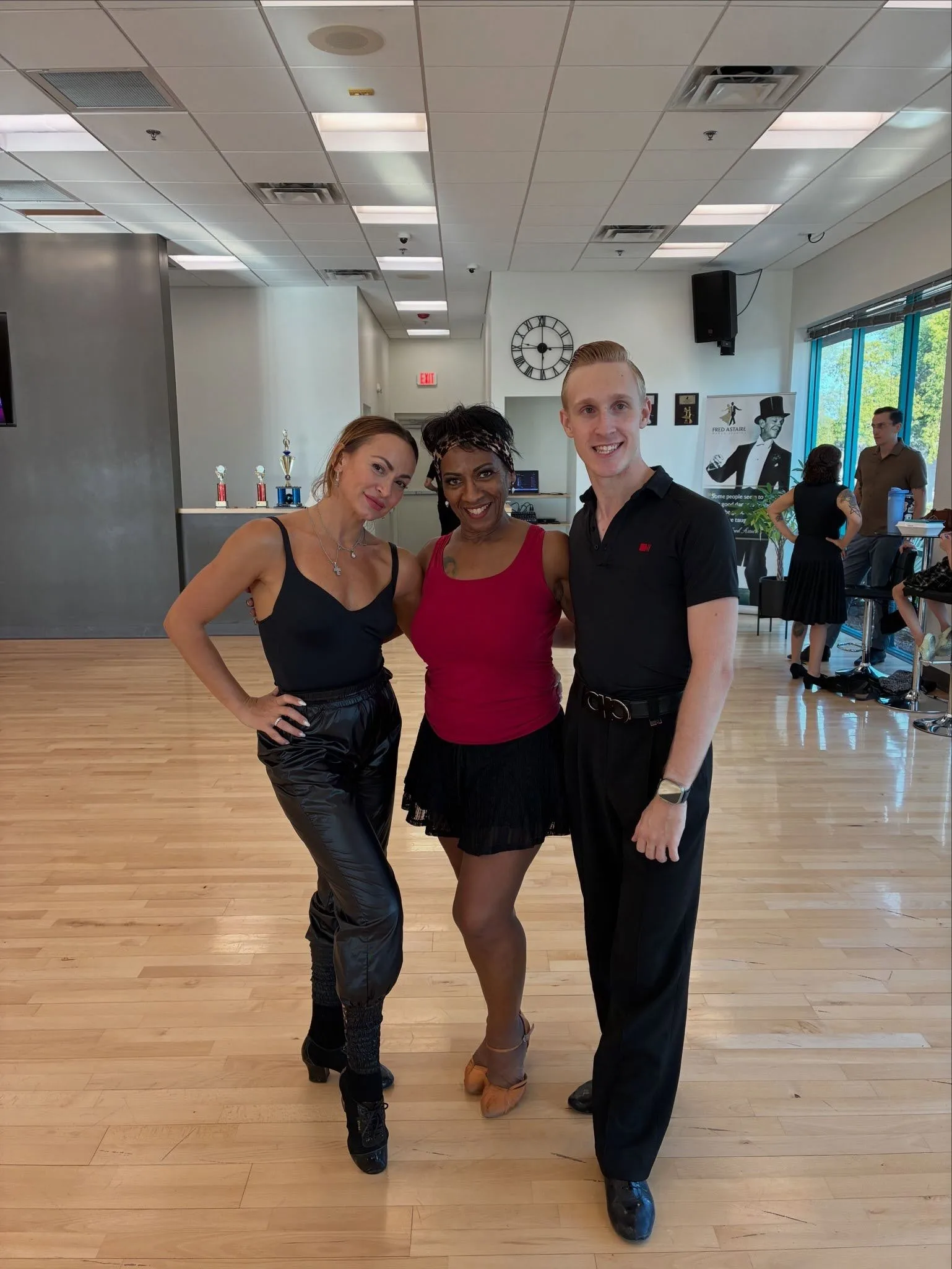 3 dancers striking a pose for the camera after showing why West Coast Swing Is The Hottest Dance Style.