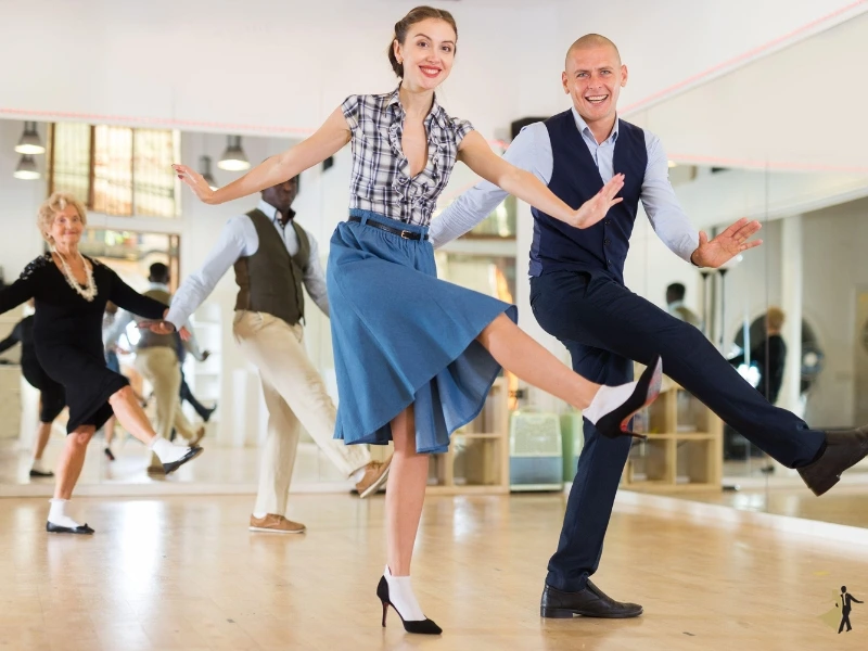 Young man and woman take east coast swing dance lessons in Raleigh NC.
