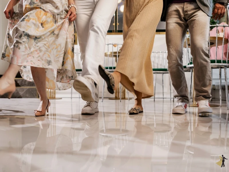 The feet of four people who are taking east coast swing dance lessons in Raleigh NC.