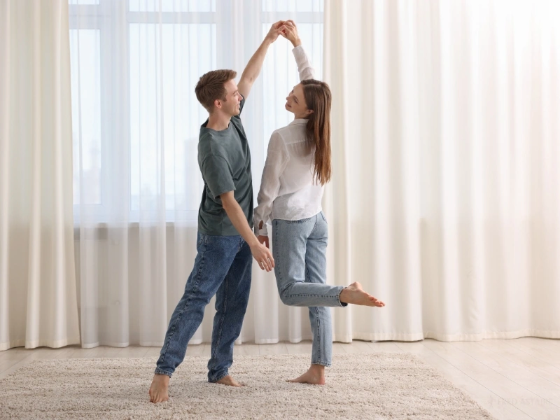 Couple dancing at home. Learn how to choreograph wedding dance at Fred Astaire Raleigh.
