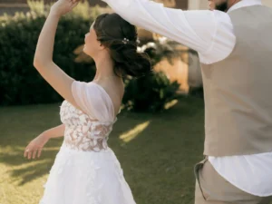 a bride dances in the sunlight. Image complements the blog, "When to Start Wedding Dance Lessons."
