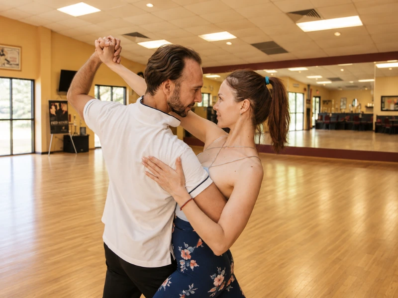 A couple shares an intimate dance in a studio, embracing love and connection.