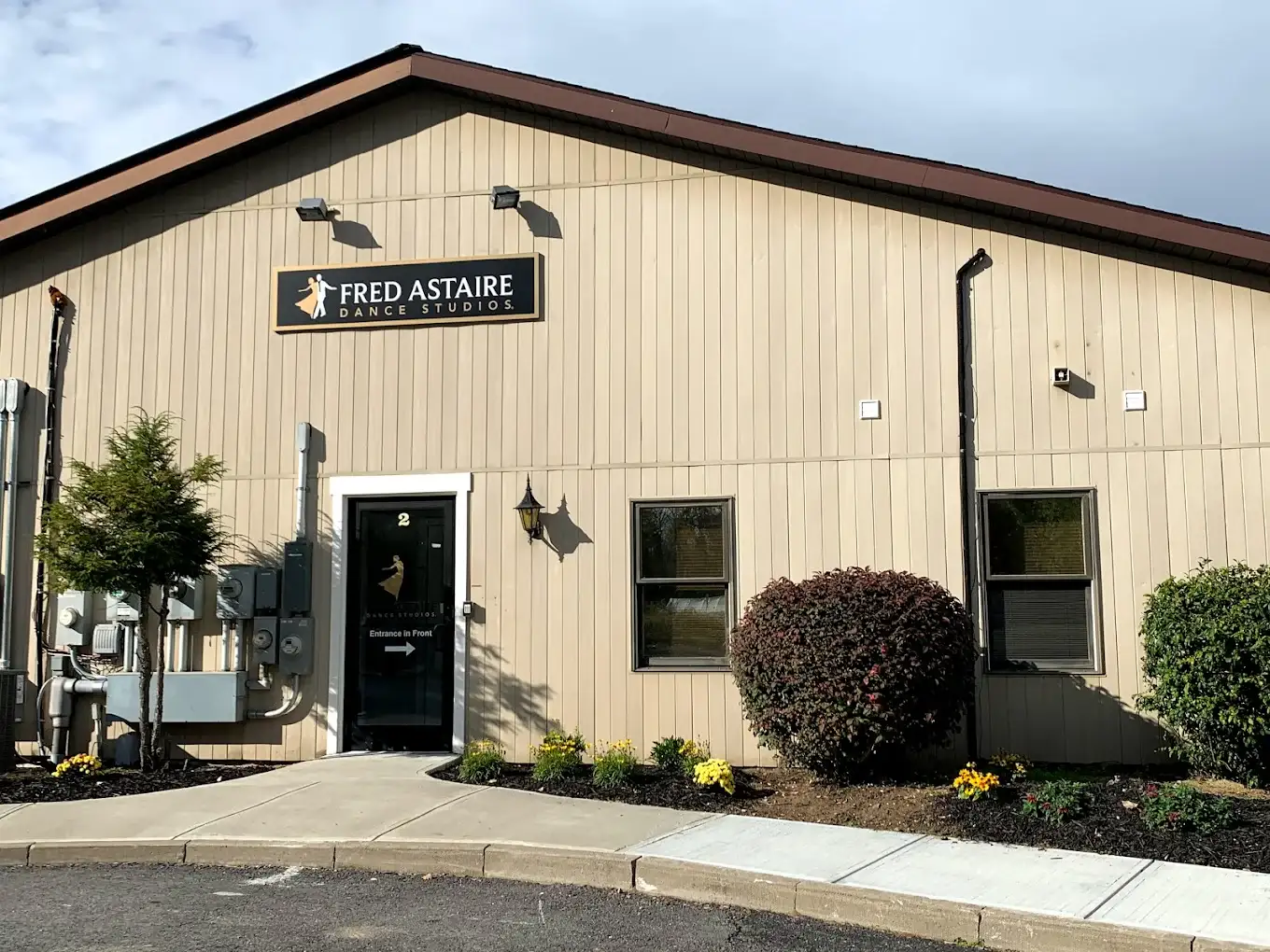 Exterior of a professional dance studio in Saratoga Springs, featuring Fred Astaire Dance Studios and offering ballroom, Latin, and social dance lessons for adults and couples.