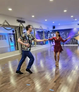 A couple practices ballroom dancing together, highlighting the fun and connection of a Dance Class in Saratoga Springs.