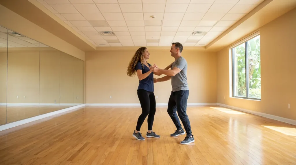 Couple taking a dance lesson together with an instructor