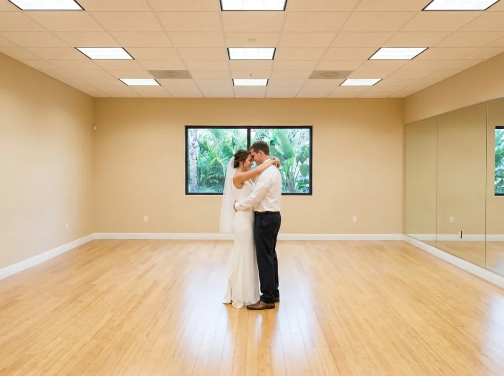 Wedding dance instructor helping a couple practice their first dance in a studio.