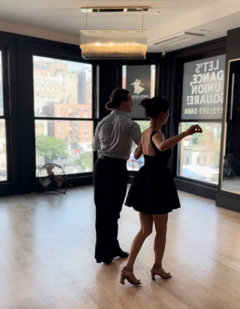 Dance instructor and student practicing together in a bright studio during Salsa Classes in Union Square.